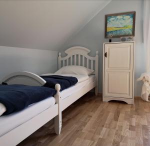 a bedroom with two beds and a painting on the wall at Ranczo w Dolinie Karpia - blisko "Energylandii" Zator in Spytkowice