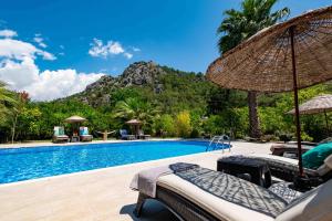 a resort swimming pool with a mountain in the background at Portalimo Lodge Hotel - Adult Only +12 in Cıralı