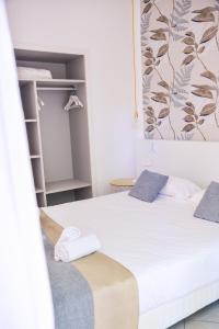 a bedroom with two beds with towels on them at Prea Gianca in Bonifacio