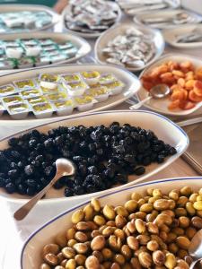 a table topped with plates of olives and other foods at Kekova Hotel in Kaş