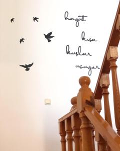 a staircase with birds stenciled on a wall at Kekova Hotel in Kaş