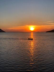 a boat in the water at sunset at Kekova Hotel in Kaş