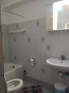 a bathroom with a toilet and a sink at Econa Residence in Poros