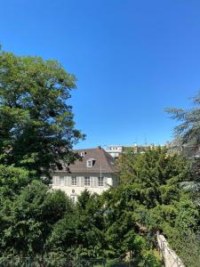 a house in the middle of some trees at Le Relais de l'Orangerie in Strasbourg
