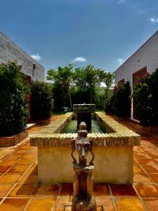 a fountain in the middle of a courtyard at SPIRIT GARDEN Tarifa in Tarifa