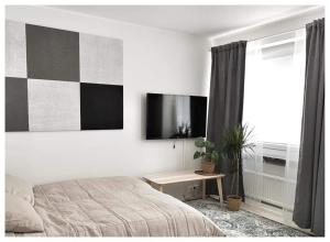 a bedroom with a bed and a table and a window at Gallen-Kallelankatu 5 in Pori