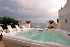 a jacuzzi tub on the balcony of a house at Palazzo Marzoli charme Resort - Small Luxury Hotel in Positano