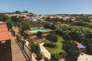an aerial view of a garden with a swimming pool at Good Feeling Hostel & Guest House in Raposeira