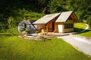 a small cabin in the middle of a field at Chalet Letnik in Žiri