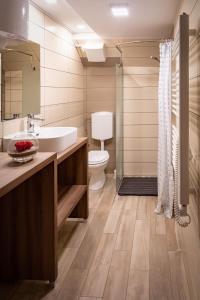 a bathroom with a tub and a sink and a toilet at Chalet Letnik in Žiri