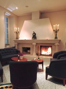 a living room with a fireplace and couches at Hotel Badehaus Goor in Putbus