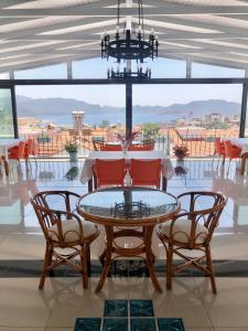 a dining room with a glass table and four chairs at Kekova Hotel in Kas