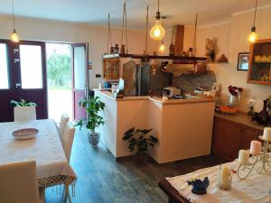 a kitchen and dining room with a table and a counter at La California in Marina di Bibbona