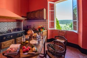 a kitchen with a table with fruits and vegetables on it at Location prestige 450 m2 dans Château en Provence in Brue-Auriac