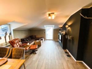a living room with a couch and a table at Boutique Apartment Anne in Bad Harzburg