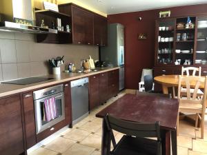 a kitchen with a table and a dining room at Seven Sisters Apartments with Self Check-In in Liepāja