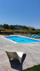 a swimming pool with a bench in front of it at Cargal leiria in Leiria