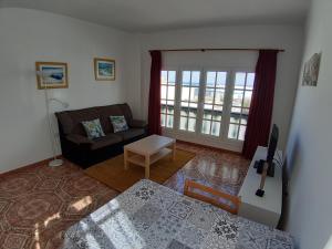 salon z kanapą i stołem w obiekcie Apartamentos Orzola w mieście Orzola +37 zdjęć