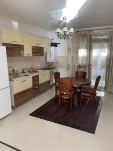 a kitchen with a dining room table and chairs at Vila Pati in Ploieşti