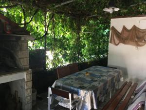 a patio with a table and chairs and trees at “Kiko” sea apartments in Mirce