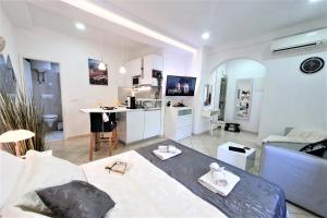 a living room with a bed and a kitchen at LUXOR Hvar - Main Square Apartments in Hvar
