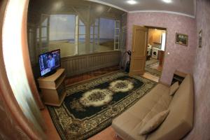 a view of a living room with a couch and a television at Апартаменты у Вокзала in Prokop'yevsk