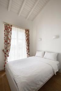 Postel nebo postele na pokoji v ubytování Alakapi Hotel & Villas