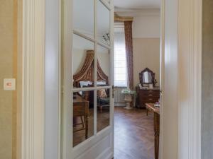 a room with a mirror and a room with a desk at Hotel Dufays in Stavelot