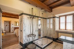 a bathroom with a glass shower in a room at Convento La Perla in Carrara