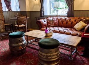 a living room with a couch and a coffee table at The Sun Inn in Penrith