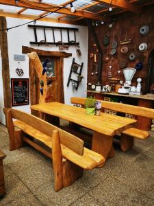 a wooden table and benches in a restaurant at Landhotel Engel in Limbach