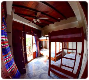 a room with two bunk beds and a ceiling fan at Esperanto Bed & Breakfast Surf Hostel in Montañita