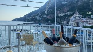 a bucket filled with bottles of wine on a balcony at Hotel Marina Riviera in Amalfi