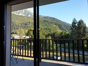 a balcony with a table and a view of a mountain at Studio refait à neuf in Saint-Jean-Saint-Nicolas
