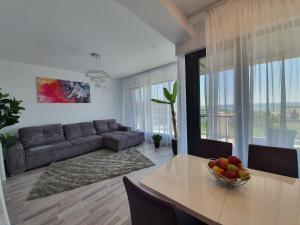 a living room with a table and a couch at Apartament Lux Eika in Mamaia Sat/Năvodari