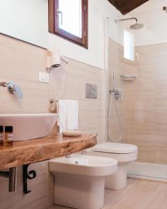 a bathroom with a toilet and a sink at Hotel Villa Giulia in Marzamemi