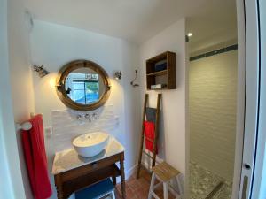 a bathroom with a sink and a mirror at Une Maison en Touraine in Saint-Branchs +24 photos