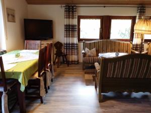 a living room with a bed and a table and chairs at Schwarzwald - Villa Appartments Titisee in Titisee-Neustadt