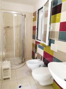 a bathroom with a shower and a toilet and a sink at Margherita Rimini - Appartamenti al Mare in Rimini +87 photos