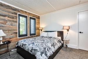 a bedroom with a bed and a wooden wall at 2 BR Ski In Out at Cachet Crossing, Sleeps 8 in Blue Mountains
