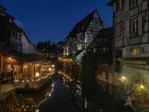 コルマールにある"appartement au centre & parking" Logement Petite Veniseの夜の街の運河
