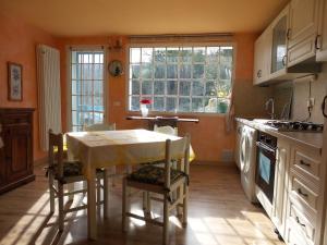a kitchen with a table and chairs and a window at La Paloma casa vacanze in Lucinasco