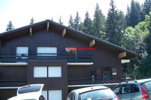 a building with cars parked in front of it at Appartement T3 Cosy St Gervais les Bains -Grattague in Mémontel