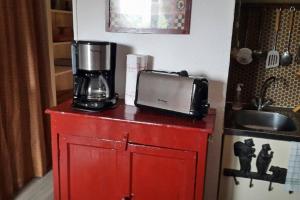 a red cabinet with a blender on top of it at Appartement T3 Cosy St Gervais les Bains -Grattague in Mémontel