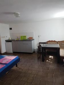 a living room with a table and a kitchen at APP-AMELIJAS in Zambratija