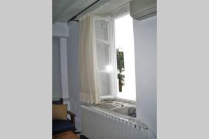 a bathroom with a window with a bath tub in it at Nikos & Efi Fabrica Residence in Megali Ammos