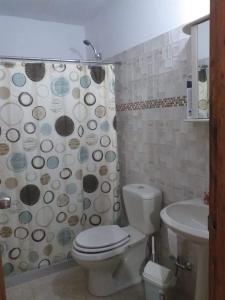 a bathroom with a toilet and a sink and a shower at ELIMAR in Playa Verde