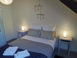 a bedroom with a bed and a lamp at Chez Yann et Valérie in Pont-Aven