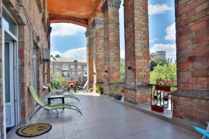 an outdoor patio with two chairs and a table at Light Life Hostel in Kyiv