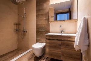 a bathroom with a toilet and a sink and a shower at Play On The Sand in Adamantas +53 photos